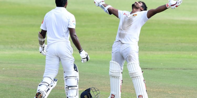 Kusal Perera stretches his arms and looks skyward after taking Sri Lanka to a one-wicket win at Durban as Viswa Fernando joins him for celebration, Saturday