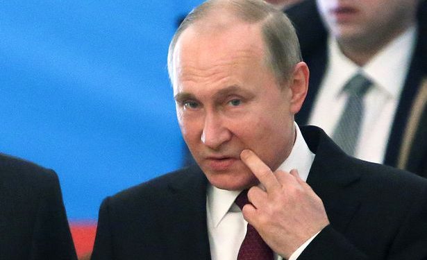 Russian President Vladimir Putin at a polling station during the presidential election in Moscow (REUTERS)