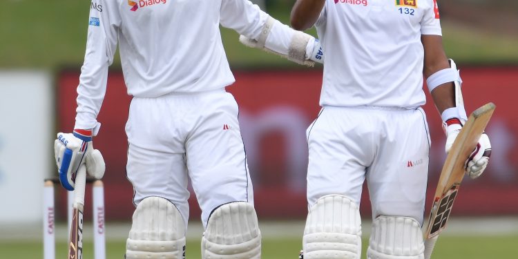 Kusal Mendis (L) and Oshada Fernando react in the field after their victory against South Africa in Port Elizabeth, Saturday