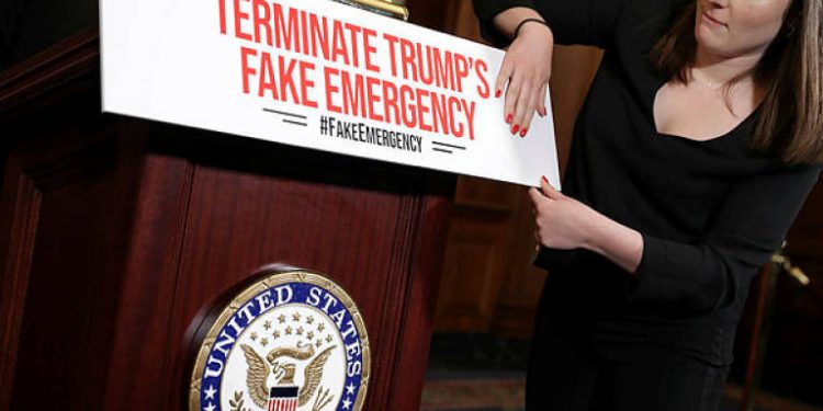 Staff from the office of Speaker of the House Nancy Pelosi (C) prepare for a news conference on the resolution to terminate President Donald Trump’s emergency declaration. (AFP)