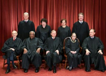 Justices of the US Supreme Court pose for their official photo on November 30, 2018: new conservative appointees Justice Neil Gorsuch and Brett Kavanaugh can be seen standing in the back row at the far left and right (AFP)