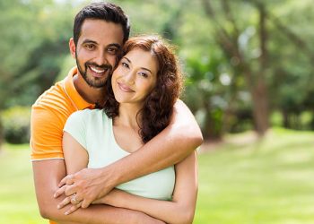 lovely young indian couple hugging outdoors