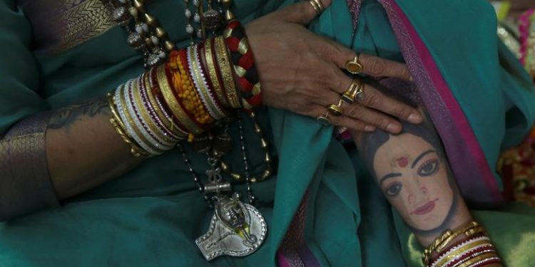 Laxmi Narayan Tripathi, chief of the "Kinnar Akhara" congregation for transgender people shows her tattoos during "Kumbh Mela", or the Pitcher Festival, in Prayagraj, previously known as Allahabad, India, January 16, 2019. (REUTERS/Danish Siddiqui)