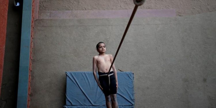 A participant practices "Mallakhamb" (traditional Indian gymnastics) while suspended from a rope during a practice session for the upcoming competition to promote the sport, in Ahmedabad, India, January 28, 2019. (REUTERS/Amit Dave)