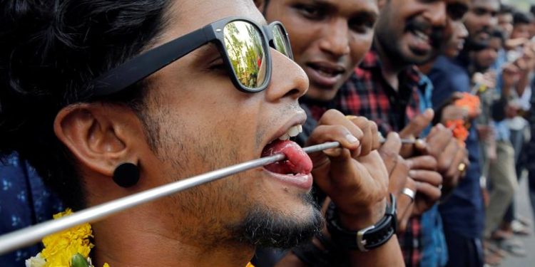 A Hindu devotee with his tongue pierced with a metal skewer takes part in a procession during the Thaipusam festival on the outskirts of Kochi, India, January 21, 2019. (REUTERS/Sivaram V)