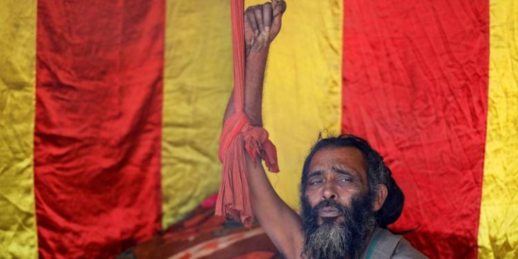 A Sadhu, or Hindu holy man, who has not moved his arm and cut his fingernails for 10 years, sits inside his camp during "Kumbh Mela", or the Pitcher Festival, in Prayagraj, previously known as Allahabad, India, January 17, 2019. (REUTERS/Danish Siddiqui)
