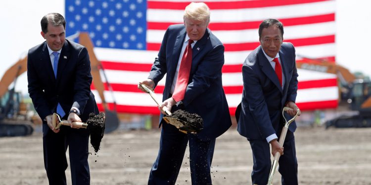 U.S. President Donald Trump, center, takes part in a groundbreaking with Wisconsin Gov. Scott Walker, left, and Foxconn Chairman Terry Gou at Foxconn's new site in Mount Pleasant, Wisconsin, on June 28. (Reuters)
