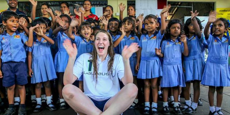 Seenigama: In this October 6, 2015 photo, Laureus Ambassador and Olympic gold medalist Missy Franklin poses for a picture with children at an event in Seenegama, Sri Lanka. (Laureus/PTI Photo)  (PTI2_19_2019_000041B)