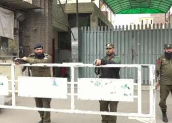 Armed guards outside JuD headquarters