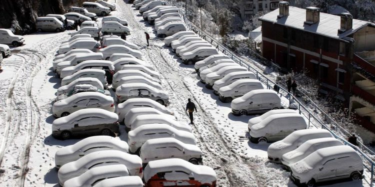 A view of snow-covered cars in Shimla February 8. (IANS)