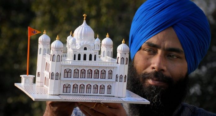Artist Gurpreet Singh shows his paper model of Kartarpur Sahib gurdwara (PTI)