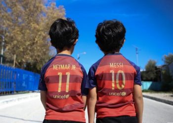 Refugee children wear Barcelona FC jersey shirts in Mytilene city, on the island of Lesbos