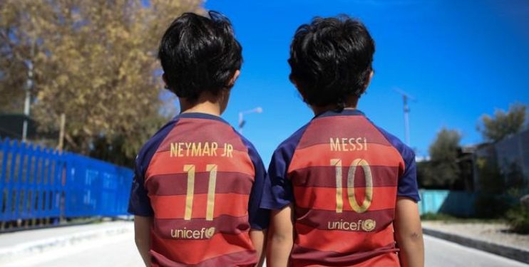 Refugee children wear Barcelona FC jersey shirts in Mytilene city, on the island of Lesbos
