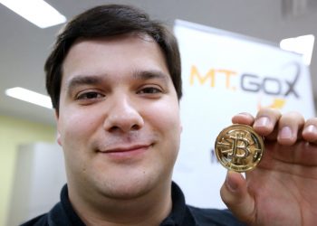 Mark Karpeles, chief executive officer of Tibanne Co., poses for a photograph with a bitcoin in the office operating the Mt.Gox K.K. bitcoin exchange in Tokyo, Japan, on Thursday, April 25, 2013. Bitcoin digital currency, which carries the unofficial ticker symbol of BTC, was unveiled in 2009 by an unidentified programmer, or group of programmers, under the name of Satoshi Nakamoto. Supply is capped at 21 million Bitcoins and managed by a software algorithm embedded into the digital currency?s design, rather than a monetary authority such as a central bank. (Photographer: Tomohiro Ohsumi/Bloomberg via Getty Images/AFP)