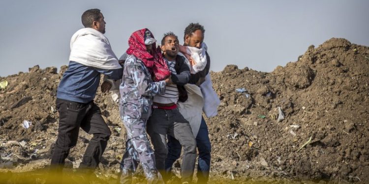 A grieving relative who lost his wife in the crash is helped by a member of security forces and others at the scene where the Ethiopian Airlines Boeing 737 Max 8 crashed shortly after takeoff on Sunday killing all 157 on board, near Bishoftu, or Debre Zeit, south of Addis Ababa, in Ethiopia Wednesday, March 13, 2019. Much of the world, including the entire European Union, has grounded the Boeing jetliner involved in the Ethiopian Airlines crash or banned it from their airspace, leaving the United States as one of the few remaining operators of the plane involved in two deadly accidents in just five months. (AP)