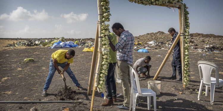 Workers erect floral installations at the scene where the Ethiopian Airlines Boeing 737 Max 8 crashed shortly after takeoff on Sunday killing all 157 on board, near Bishoftu, or Debre Zeit, south of Addis Ababa, in Ethiopia Wednesday, March 13, 2019. Much of the world, including the entire European Union, has grounded the Boeing jetliner involved in the Ethiopian Airlines crash or banned it from their airspace, leaving the United States as one of the few remaining operators of the plane involved in two deadly accidents in just five months. (AP)
