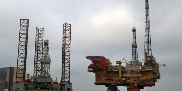 The five biggest publicly listed oil and gas majors made profits of $55 billion in 2018 (AFP)