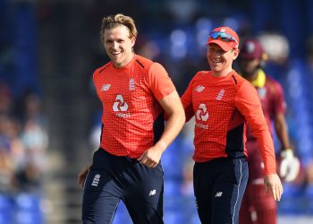 David Willey (L), along with England skipper Eoin Morgan, is all smiles after dismissing a Windies batsman, Sunday