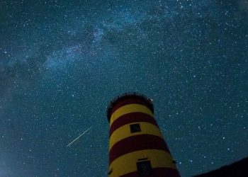 A falling star crosses the night sky behind a lighthouse is pictured during the peak in activity of the annual Perseids meteor shower Aug. 13, 2015 in Pilsum, Germany. (AFP) [Representational Image]