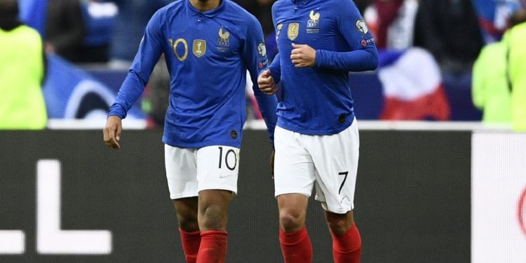 Kylian Mbappe (L) and Antoine Griezmann celebrate the former’s goal against Iceland, Monday