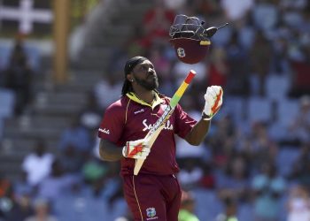 Chris Gayle celebrates after he scored half a century against England in the final ODI at the Daren Sammy Cricket Ground in Gros Islet, Saturday