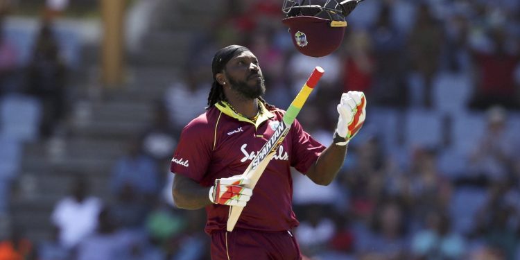 Chris Gayle celebrates after he scored half a century against England in the final ODI at the Daren Sammy Cricket Ground in Gros Islet, Saturday