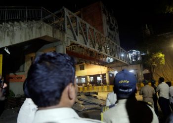 Policemen and others gather near a pedestrian bridge that collapsed in Mumbai. (AP)
