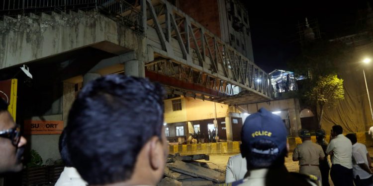 Policemen and others gather near a pedestrian bridge that collapsed in Mumbai. (AP)