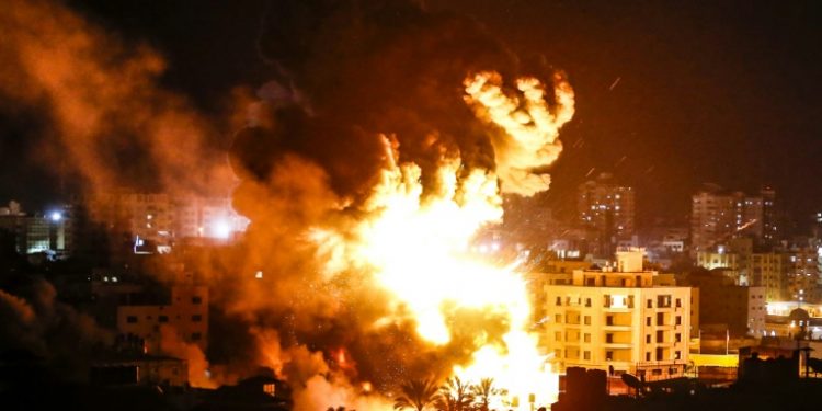 Fire and smoke billow above buildings in Gaza City during reported Israeli strikes March 25, 2019 (AFP)