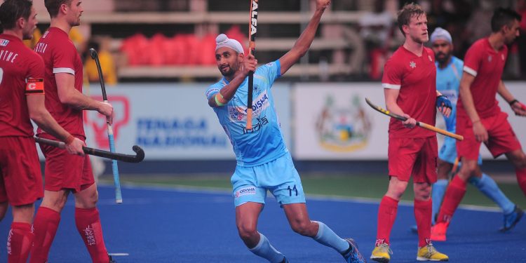 Mandeep Singh celebrates after scoring a hat-trick against Canada in Ipoh, Malaysia, Wednesday