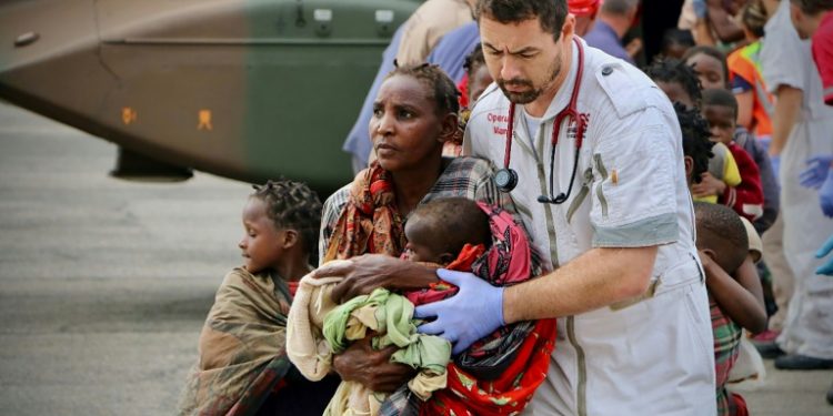 Four days after Tropical Cyclone Idai made landfall, emergency teams in central Mozambique fanned out in boats and helicopters, seeking to pluck survivors from roofs and treetops (AFP)