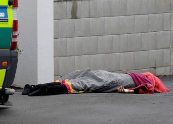 A body lies on the footpath outside a mosque in central Christchurch, New Zealand, on Friday (March 15 2019). A witness says many people have been killed in a mass shooting at a mosque in the New Zealand city of Christchurch. (Picture: Mark Baker/AP)