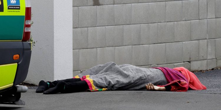 A body lies on the footpath outside a mosque in central Christchurch, New Zealand, on Friday (March 15 2019). A witness says many people have been killed in a mass shooting at a mosque in the New Zealand city of Christchurch. (Picture: Mark Baker/AP)