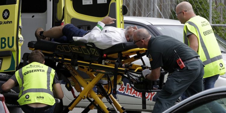 Ambulance staff take a man from outside a mosque in central Christchurch, New Zealand, Friday, March 15, 2019. A witness says many people have been killed in a mass shooting at a mosque in the New Zealand city of Christchurch. (AP Photo/Mark Baker)