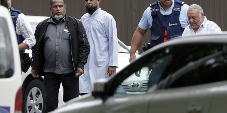 Police escort men from a mosque in central Christchurch, New Zealand, Friday, March 15, 2019. Multiple people were killed in mass shootings at two mosques full of people attending Friday prayers, as New Zealand police warned people to stay indoors as they tried to determine if more than one gunman was involved. (AP Photo/Mark Baker)