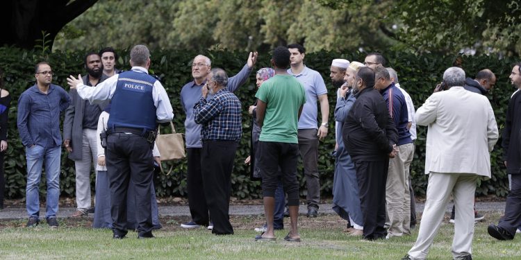 Police talk to witnesses near a mosque in central Christchurch, New Zealand, Friday, March 15, 2019. Multiple people were killed in mass shootings at two mosques full of people attending Friday prayers, as New Zealand police warned people to stay indoors as they tried to determine if more than one gunman was involved. (AP Photo/Mark Baker)