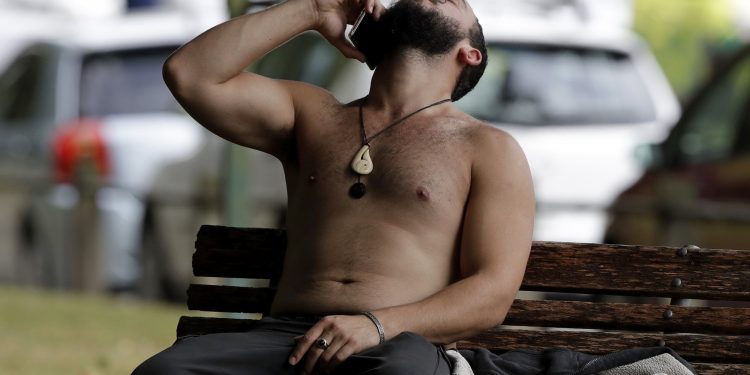 A man reacts as he speaks on a mobile phone near a mosque in central Christchurch, New Zealand, Friday, March 15, 2019. Multiple people were killed in mass shootings at two mosques full of people attending Friday prayers, as New Zealand police warned people to stay indoors as they tried to determine if more than one gunman was involved. (AP Photo/Mark Baker)