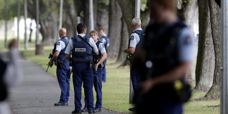 Police keep watch at a park across the road from a a mosque in central Christchurch, New Zealand, Friday, March 15, 2019. Multiple people were killed in mass shootings at two mosques full of people attending Friday prayers, as New Zealand police warned people to stay indoors as they tried to determine if more than one gunman was involved. (AP Photo/Mark Baker)