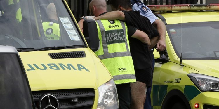Police and ambulance staff help a wounded man from outside a mosque in central Christchurch, New Zealand, Friday, March 15, 2019. A witness says many people have been killed in a mass shooting at a mosque in the New Zealand city of Christchurch. (AP Photo/Mark Baker)