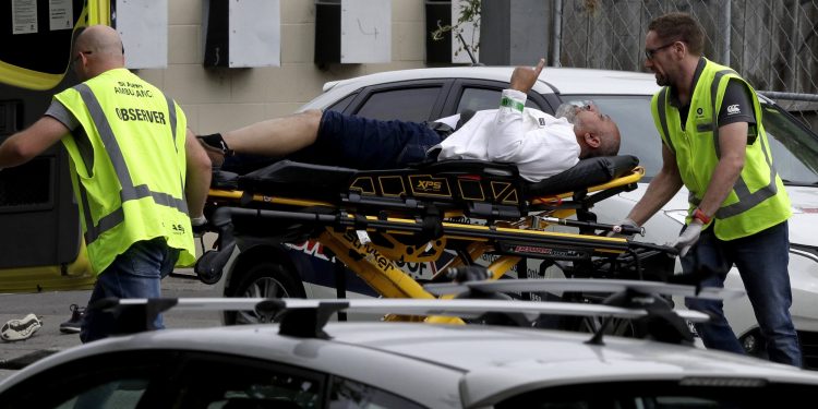 Ambulance staff take a man from outside a mosque in central Christchurch, New Zealand, Friday, March 15, 2019. A witness says many people have been killed in a mass shooting at a mosque in the New Zealand city of Christchurch.(AP Photo/Mark Baker)