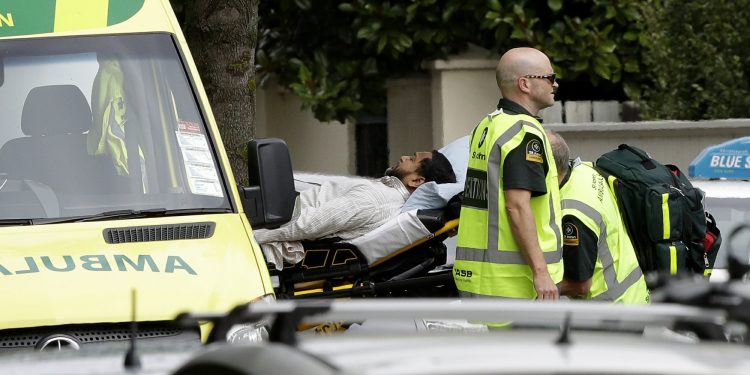 Ambulance staff take a man from outside a mosque in central Christchurch, New Zealand, Friday, March 15, 2019. A witness says many people have been killed in a mass shooting at a mosque in the New Zealand city of Christchurch. (AP Photo/Mark Baker)