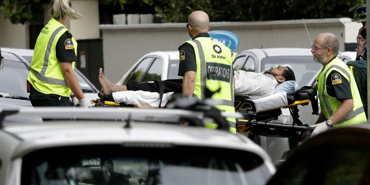 Ambulance staff take a man from outside a mosque in central Christchurch, New Zealand, Friday, March 15, 2019. A witness says many people have been killed in a mass shooting at a mosque in the New Zealand city of Christchurch.(AP Photo/Mark Baker)