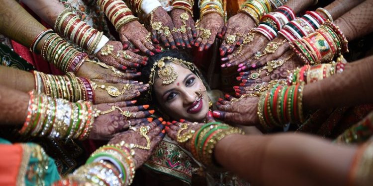 An Indian bride poses as others show off their decorated hands at a mass wedding in Surat, Gujarat (AFP [Representational Image]