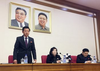 North Korean Vice Foreign Minister Choe Son Hui, center, speaks at a gathering for diplomats in Pyongyang, North Korea on Friday, March 15, 2018. North Korean leader Kim Jong Un will soon make a decision on whether to continue diplomatic talks and maintain the country's moratorium on missile launches and nuclear tests, the senior North Korean official said, noting the U.S. threw away a golden opportunity at the recent summit between their leaders. Interpreter is on Choe's right and the man standing is unidentified vice director of foreign ministry’s North America desk. (AP Photo/Eric Talmadge)