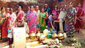 Villagers flock near the sole functioning tube-well of the village to stock water for their daily chores at Tepren