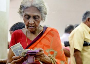 An aged woman counts her pension amount after withdrawing cash at the treasury office in Thiruvananthapuram Thursday 21 June 2018 [Representational Image] (PTI)