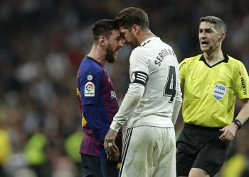 Lionel Messi (L) and Sergio Ramos are having a heated exchange of words after their collision as referee comes in to take control of the situation, Saturday