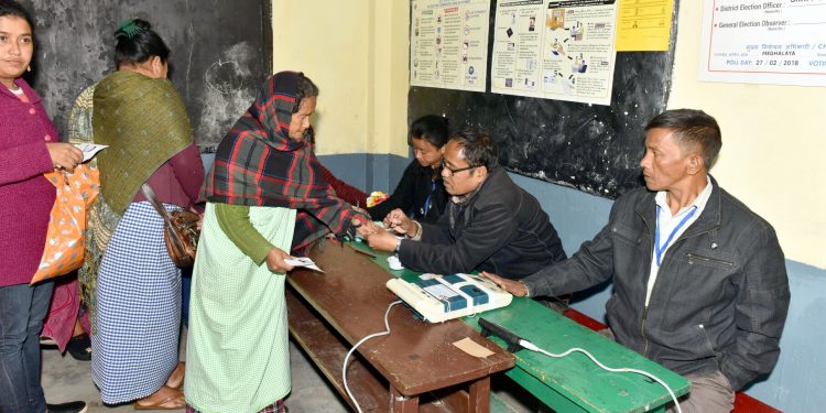 A polling official administering indelible ink to a voter, at a polling booth, during the Meghalaya Assembly Election, in Shillong on February 27, 2018.