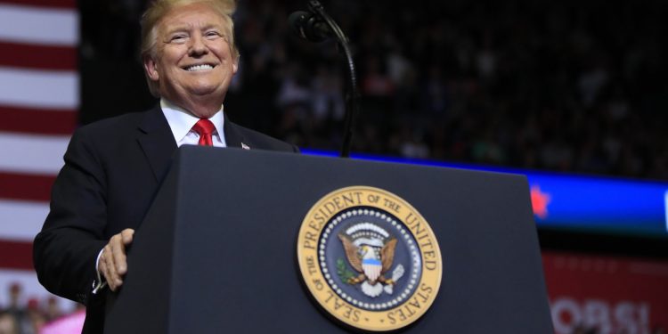 Donald Trump Jr. tosses hats to the audience during a rally in Grand Rapids, Mich., Thursday, March 28, 2019. (AP Photo/Paul Sancya)