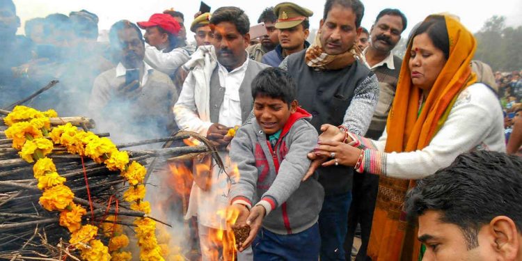 Kin of slain CRPF jawan Ram Vakeel last rites being performed during his cremation, in Mainpuri, Saturday, Feb. 16, 2019. Vakeel lost his life in Thursday's Pulwama terror attack. (PTI)
